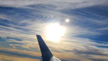 Sunrise over a plane wing over the Atlantic Ocean