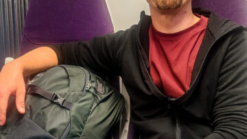 Jason with his travel backpack on the train