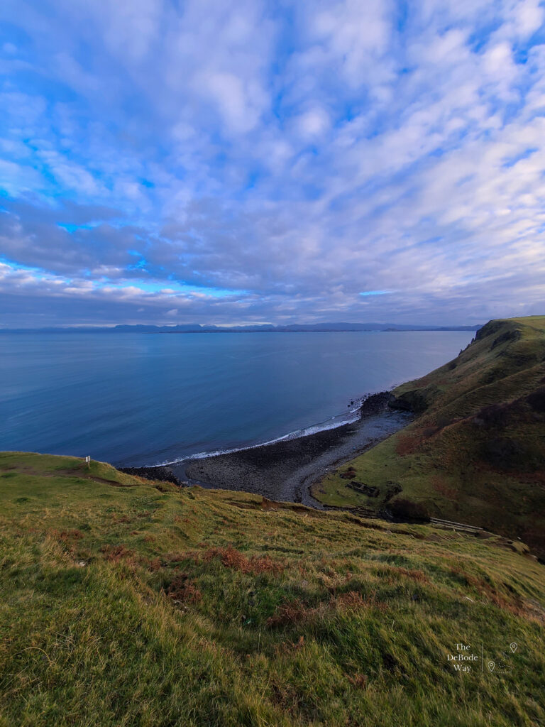Where the stream meets the sea below the green cliffs at Lealt Falls