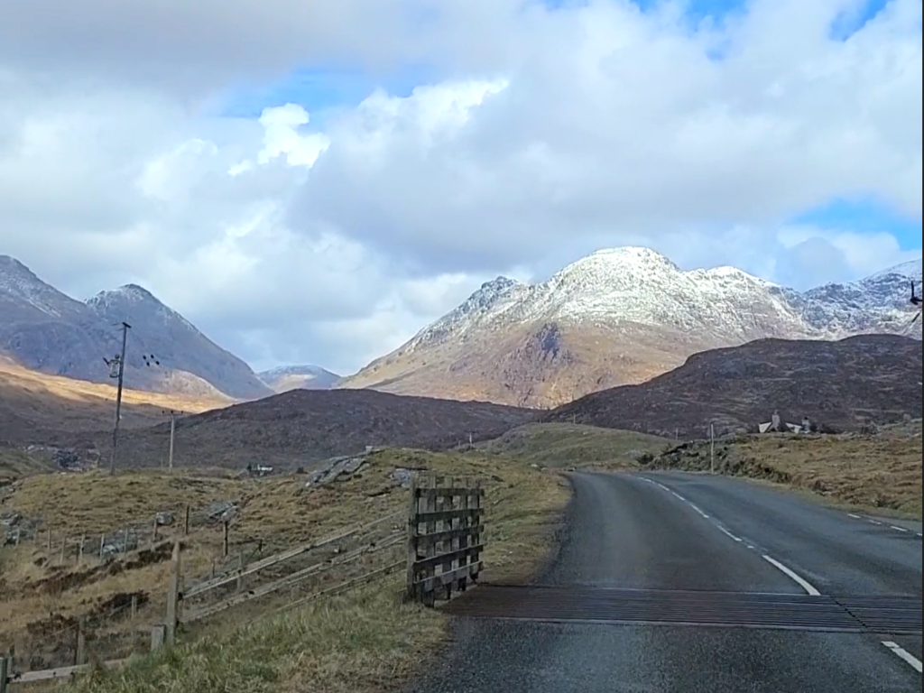 And empty highway and cattle grate leading into the highlands of the Isle of Lewis in Scotland