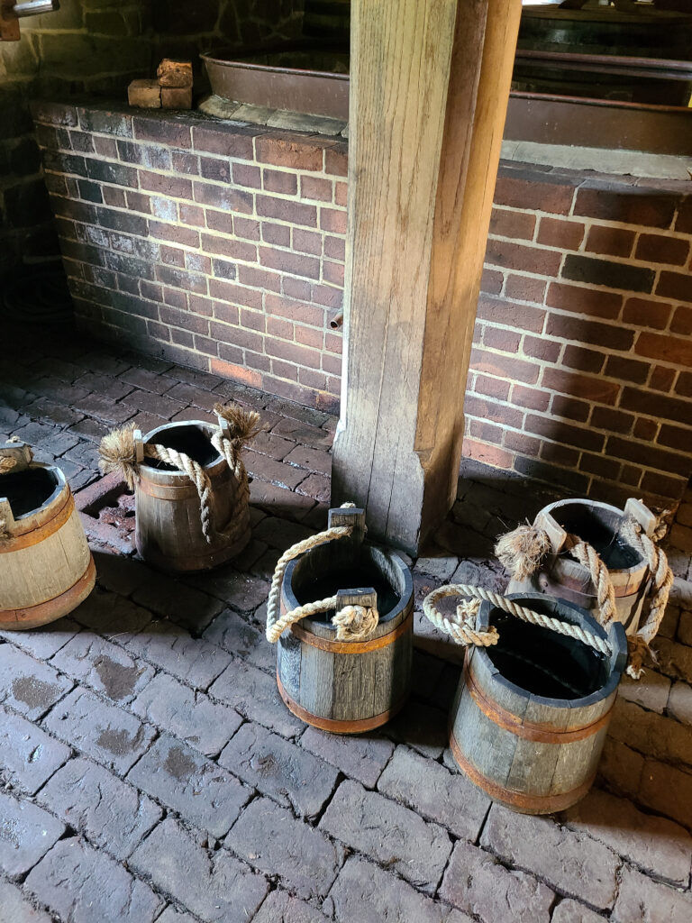 A collection of wooden buckets inside the distillery at Mount Vernon