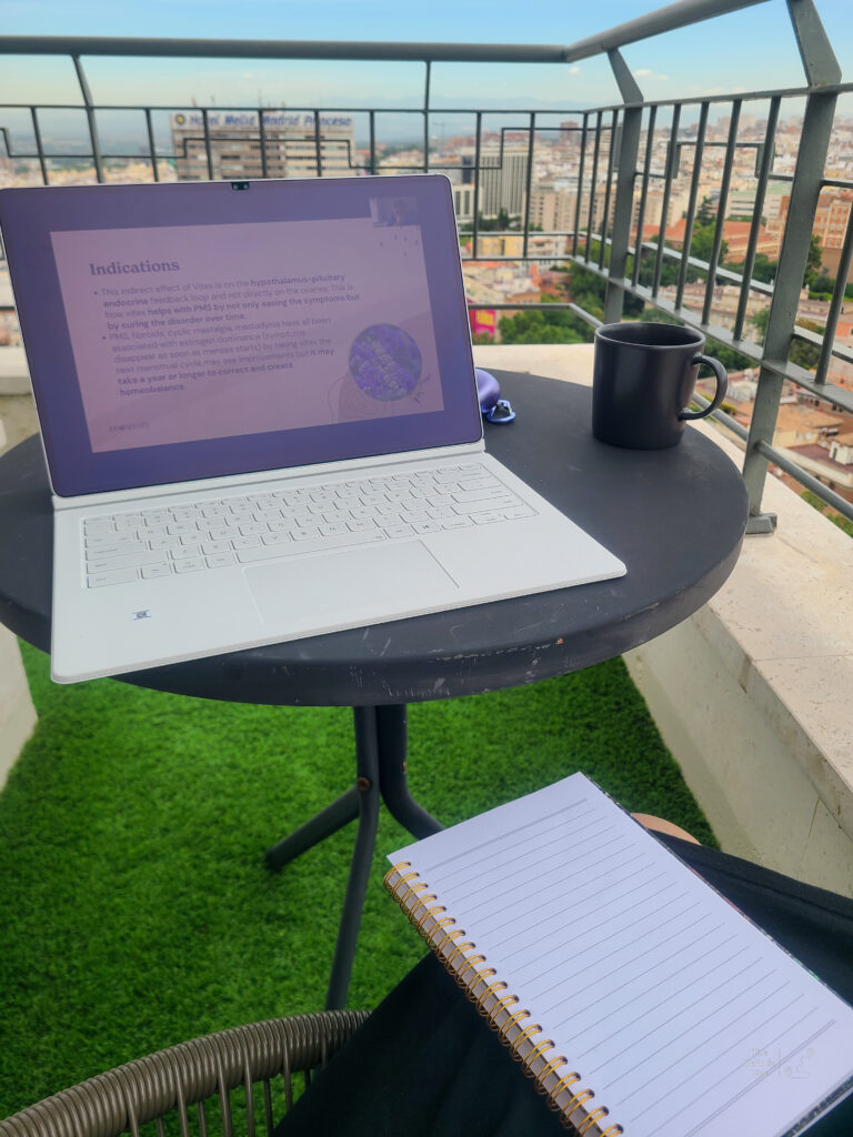 Tablet set on small round table on balconcy with mug and notebook