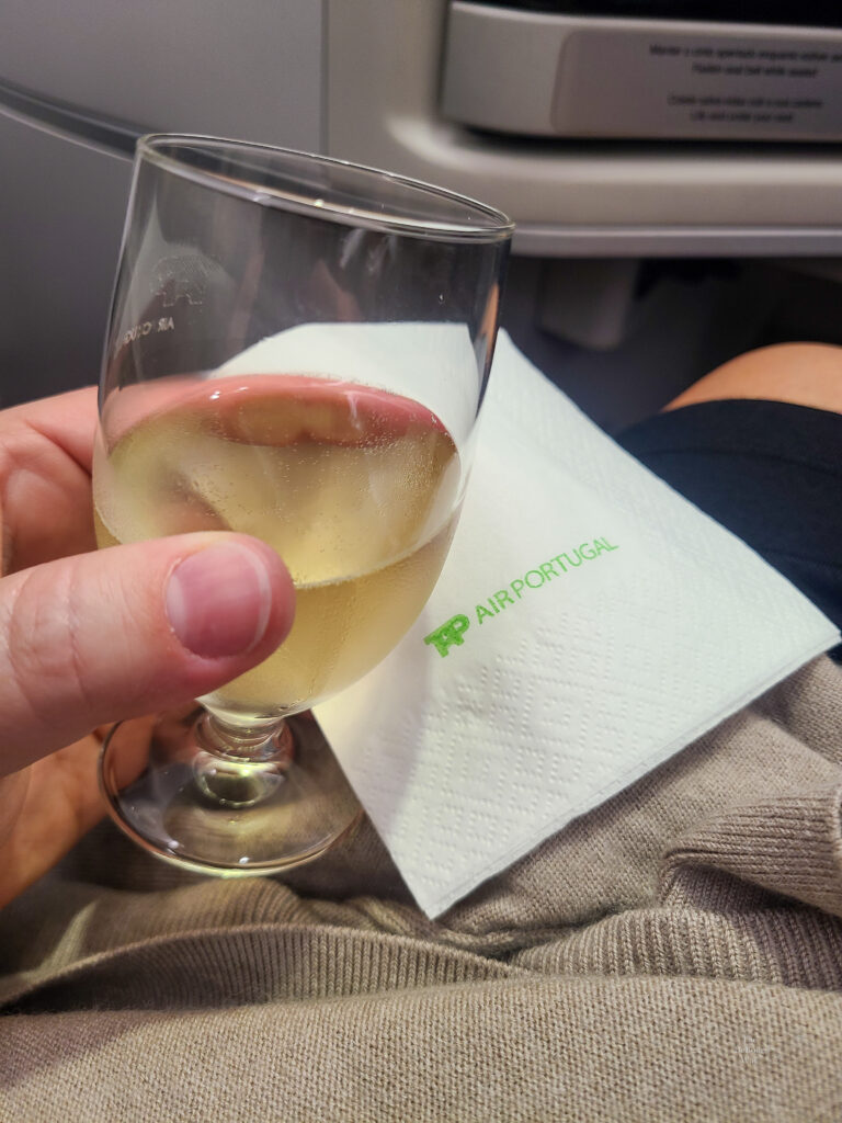 Glass of sparkling wine on TAP Air before takeoff