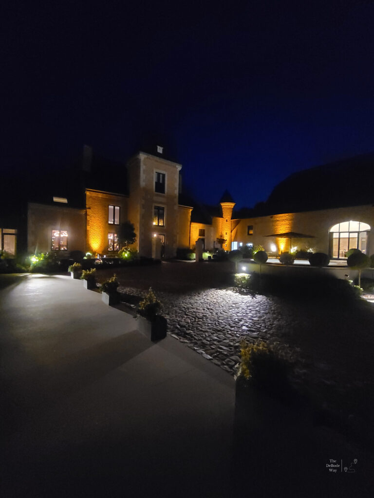 Chateau de Vignee lit up at night from the courtyard