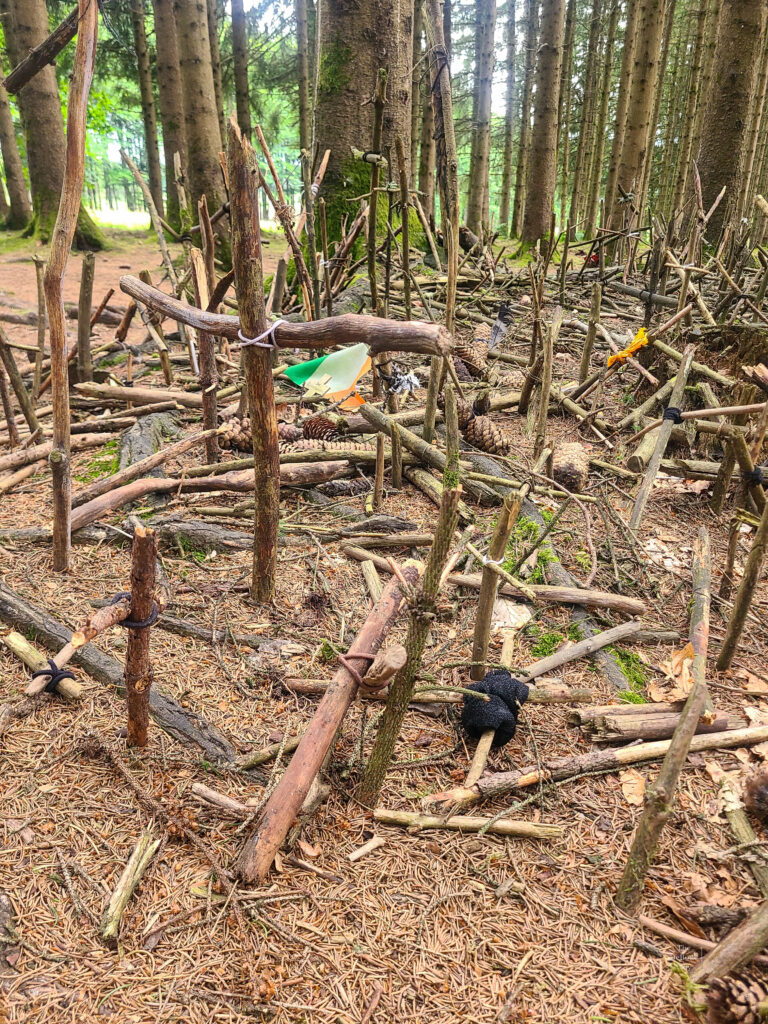 Hundreds of wooden crosses stuck into the dirt in the Ardennes Forest