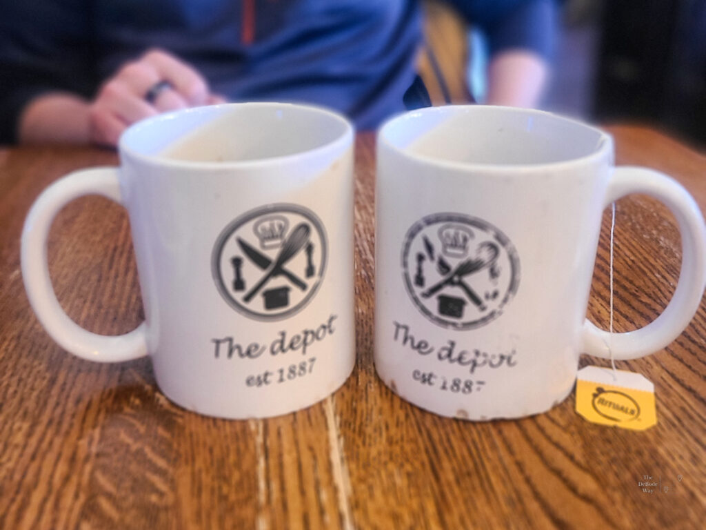 Blurry coffee mugs on a wood table top at The Depot in Leavenworth, KS.
