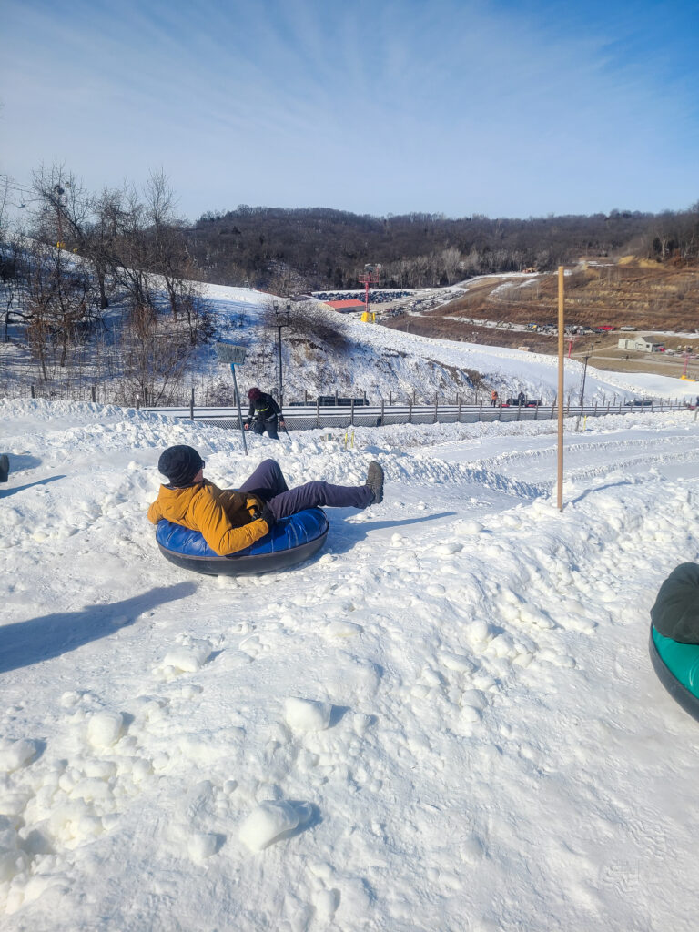Jason sitting in a snow tube at the top of the tubing run