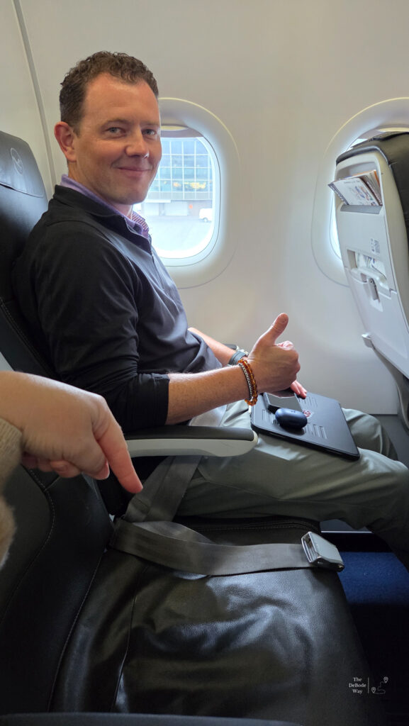 Our journey home began with an empty middle seat, thumbs up from Jason.